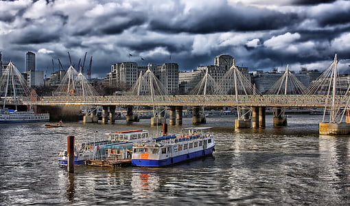 three blue and white boats near gray bridge under white clouds thumbnail