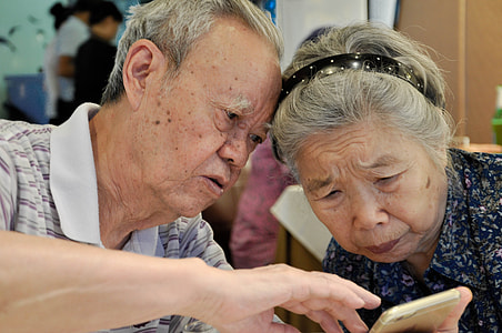 man holding gold iPhone 6 sitting beside woman thumbnail