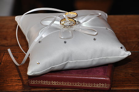 gold-colored rings on gray cushions thumbnail