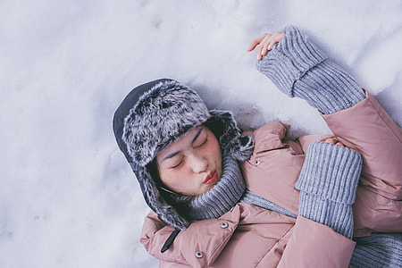 woman lying on snowy ground thumbnail