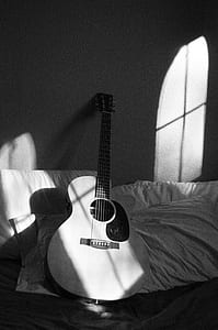 White Acoustic Guitar on Grey and White Textile thumbnail