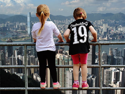 two girls climbing beside railing thumbnail