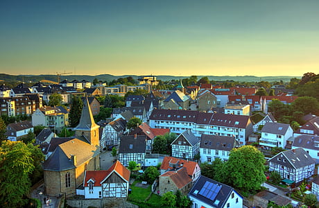 aerial photography of assorted-color buildings under blue and yellow sly at daytime thumbnail