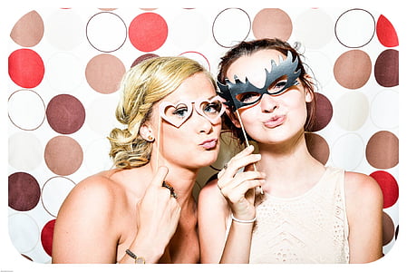 two women holding eye masks thumbnail