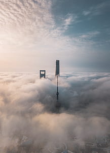 two gray building surrounded by white clouds in aerial view at daytime thumbnail