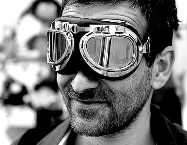 grayscale photo of man wearing protective sunglasses thumbnail