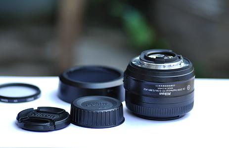 black Nikon camera lens thumbnail