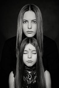 grayscale photography of woman leaning on girl's head thumbnail
