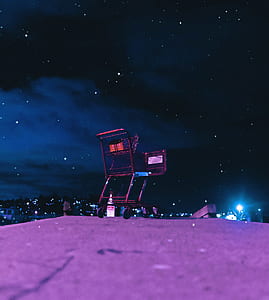 shopping cart on grey pavement during nighttime thumbnail
