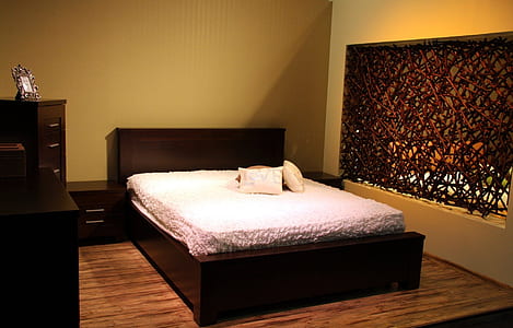 bed near drawer chest inside yellow painted room thumbnail