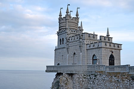 gray castle near body of water during daytime thumbnail