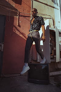 man standing on CRT television near door thumbnail