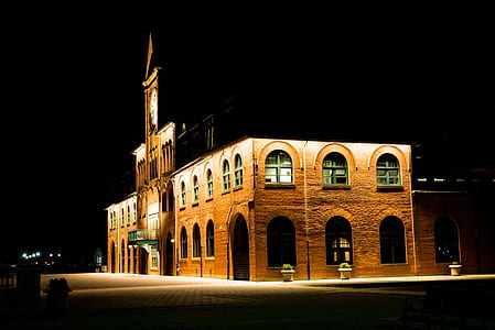 Brown Brick Building With Lights during Night Time thumbnail