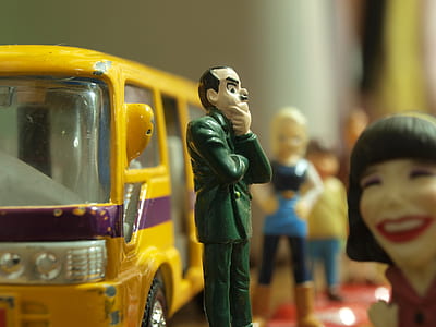 shallow focus photography of man in green suit coat plastic toy thumbnail