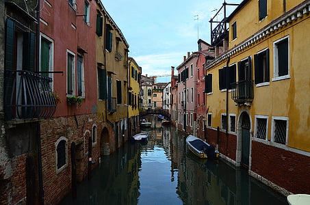 body of water in between residential buildings thumbnail