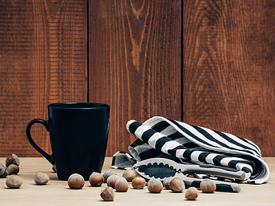 black ceramic mug and white and black textile thumbnail
