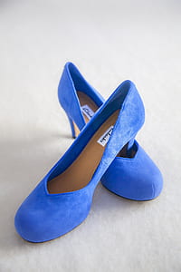 pair of blue suede stilettos on white surface thumbnail