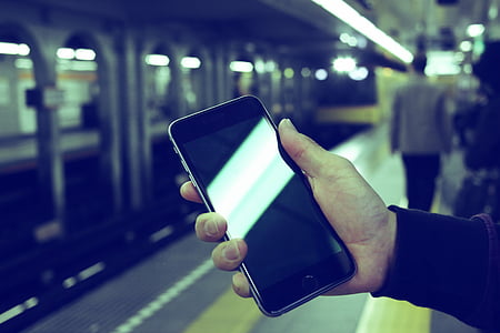 selective focus photo of person holding turned-off space gray iPhone 6 thumbnail