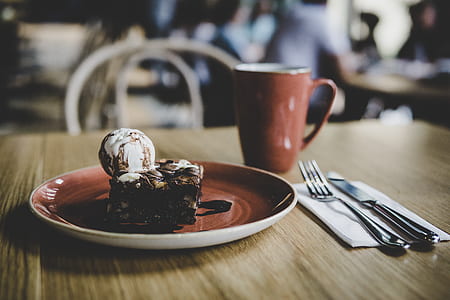slice of brownie on brown and white ceramic saucer thumbnail