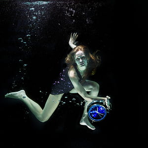 woman wearing black dress holding clock thumbnail