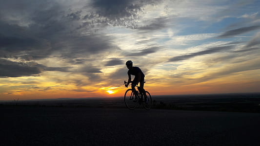 silhouette of man ride-on bicycle thumbnail