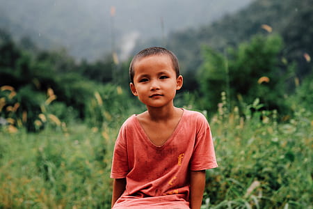 boy sittin near flowers thumbnail