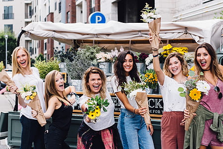 woman wearing jeans holding bouquet of flowers thumbnail