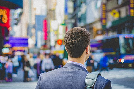 man standing on the city during daytime thumbnail