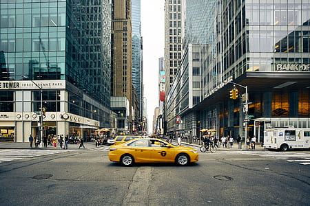 yellow sedan on street near buildings at daytime thumbnail