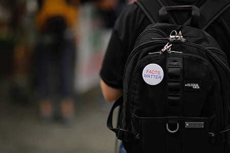 person wearing black backpack thumbnail
