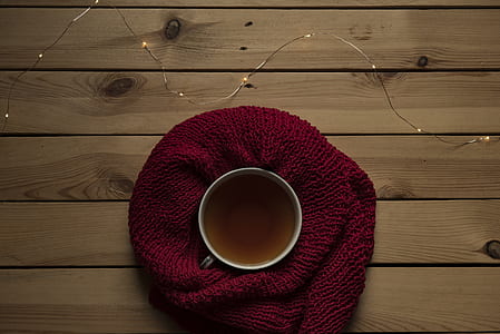 white teacup on red textile thumbnail