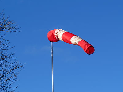red and white striped flag under blue sky thumbnail
