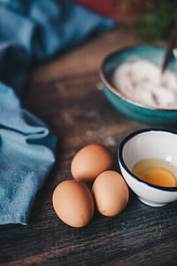 macro photography of three eggs beside white ceramic bowl thumbnail