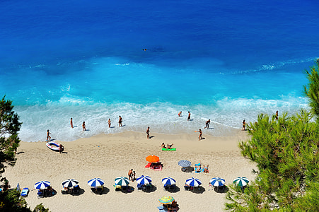 people gathering near beach during daytime thumbnail