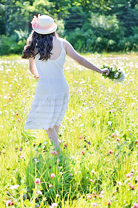 woman in white spaghetti strap dress on green-and-pink flower field during daytime thumbnail