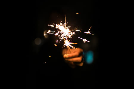 person holding lighted sparkler thumbnail