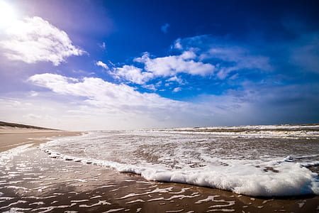 Bike Waves of Sea Under Clouded Blue Sky during Daytime thumbnail