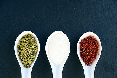 three white plastic spoons with spices thumbnail