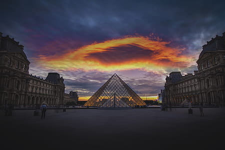 concrete buildings on gray and orange sky thumbnail