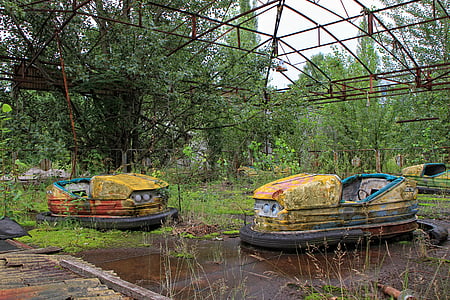two yellow abandoned bumper cars at daytime thumbnail
