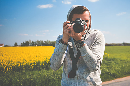Young Photographer in Action Taking a Photo thumbnail