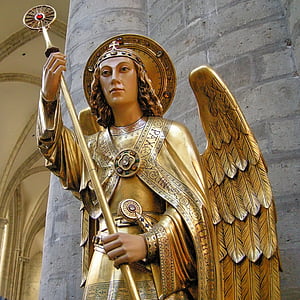 low angle of oangel wearing gold suit holding staff statue thumbnail