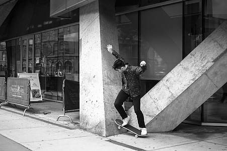 grayscale photo of person riding skateboard thumbnail