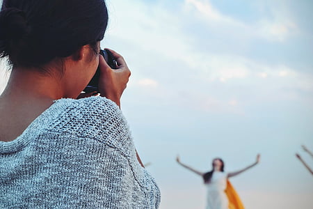 woman taking photo of person during daytime thumbnail