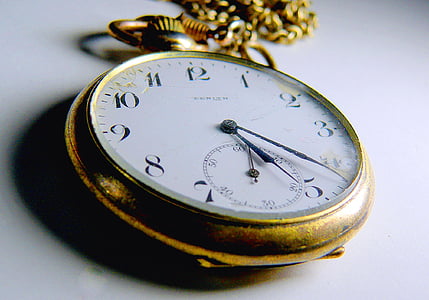gold-colored pocket watch reading at 5 23 thumbnail