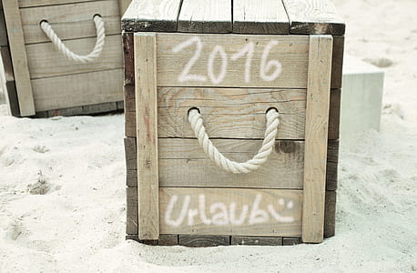 brown wooden box on white sand thumbnail
