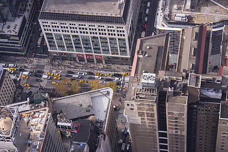 aerial photography of high-rise buildings and vehicles on road thumbnail