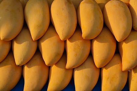 close view of three stacks of yellow mango fruit thumbnail