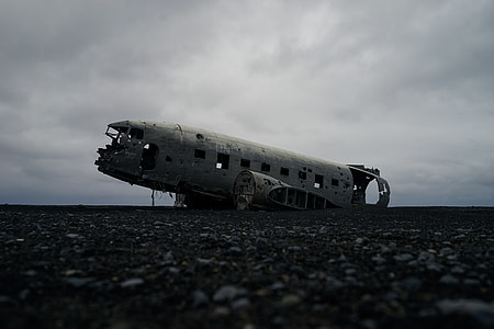 abandoned plane on ground under white clouds thumbnail