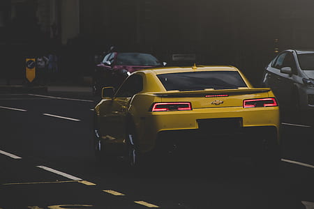 yellow Chevrolet Camaro at the city road thumbnail